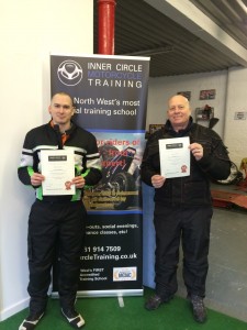 Camren and Steve show off their Inner Circle certificates after passing their bike tests