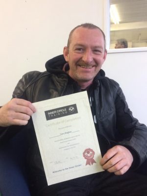 Cory with is "DAS course completion" certificate after passing his motorcycle test